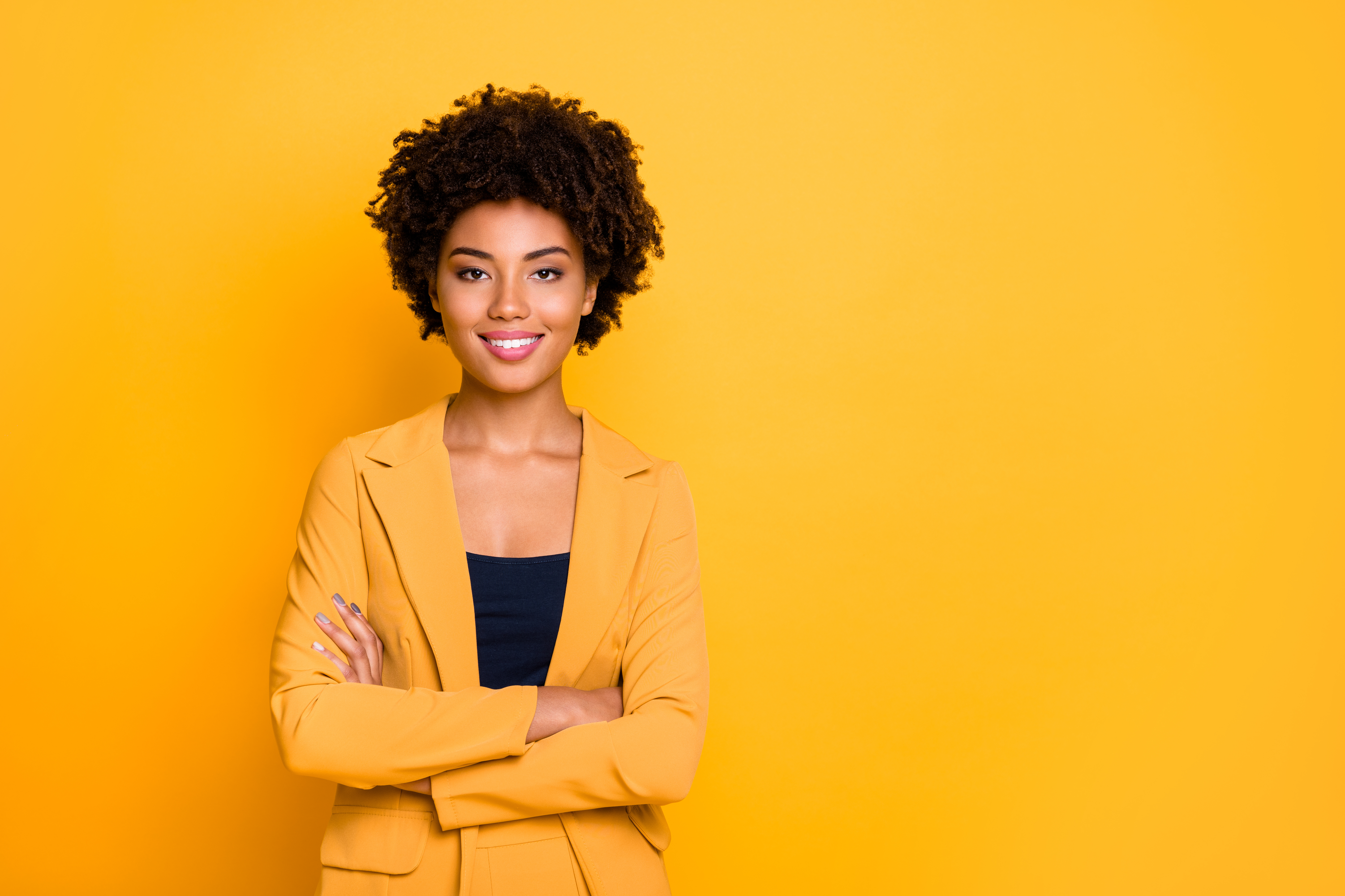 Portrait of her she nice well-dressed attractive lovely luxury pretty content cheerful cheery wavy-haired girl folded arms isolated over bright vivid shine vibrant yellow color background